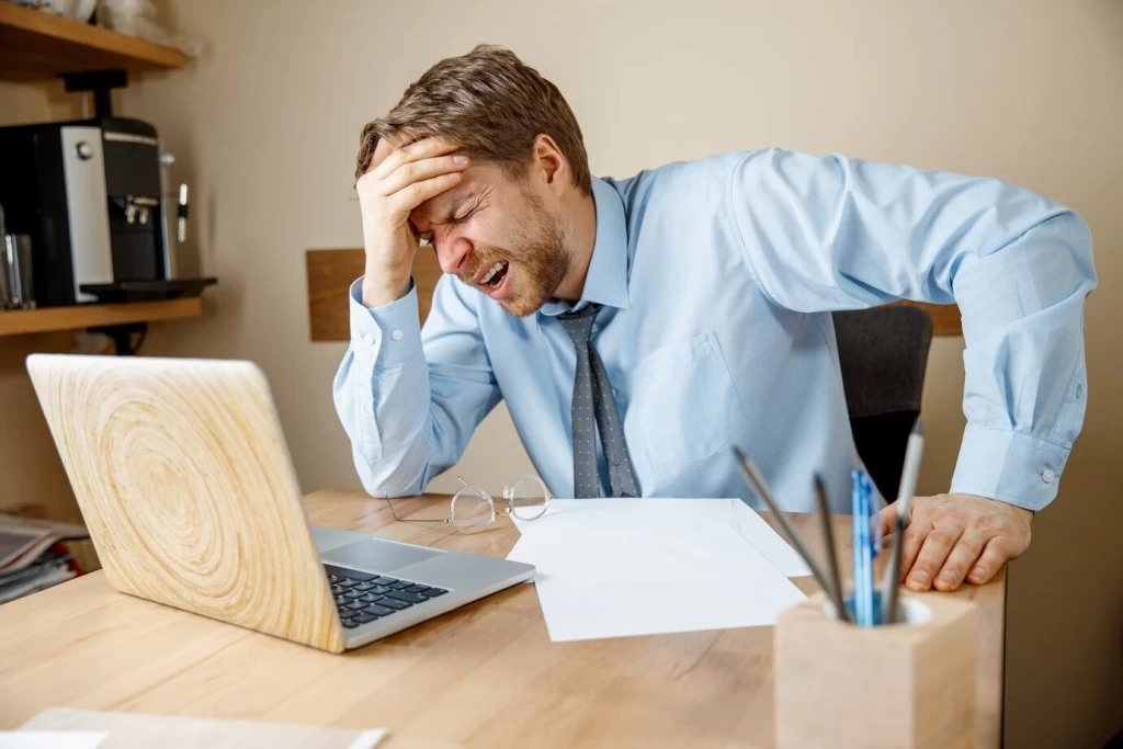 feeling-sick-tired-frustrated-sad-unhappy-sick-young-man-massaging-his-head-while-sitting-his-working-place-office_155003-18100.jpg