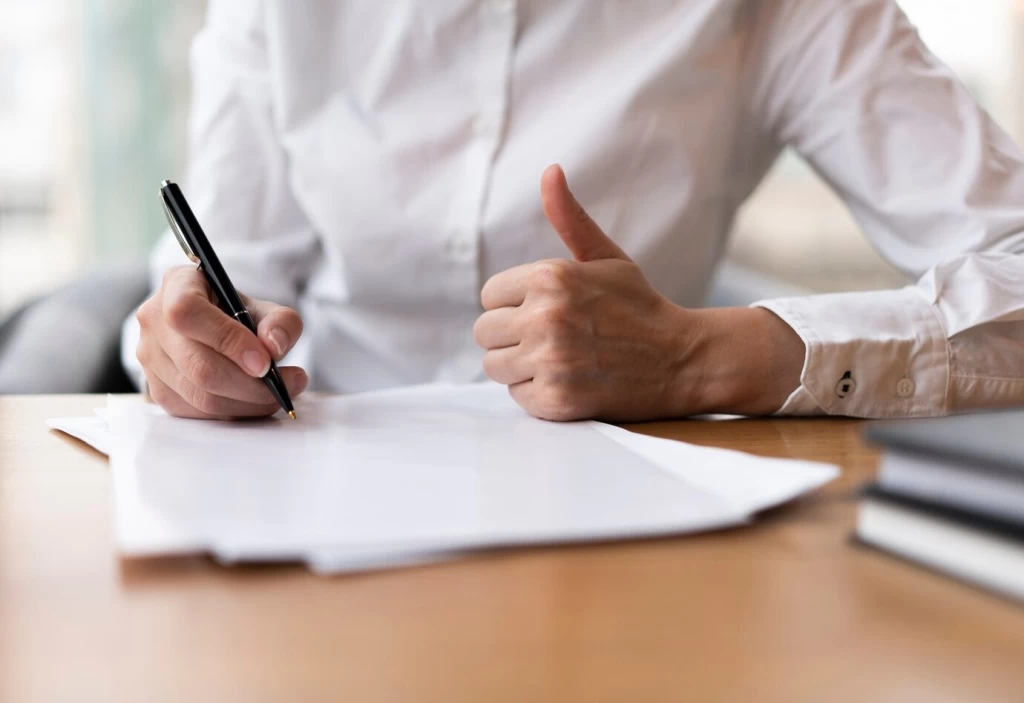 woman-writing-showing-thumbs-up_23-2148377788.jpg